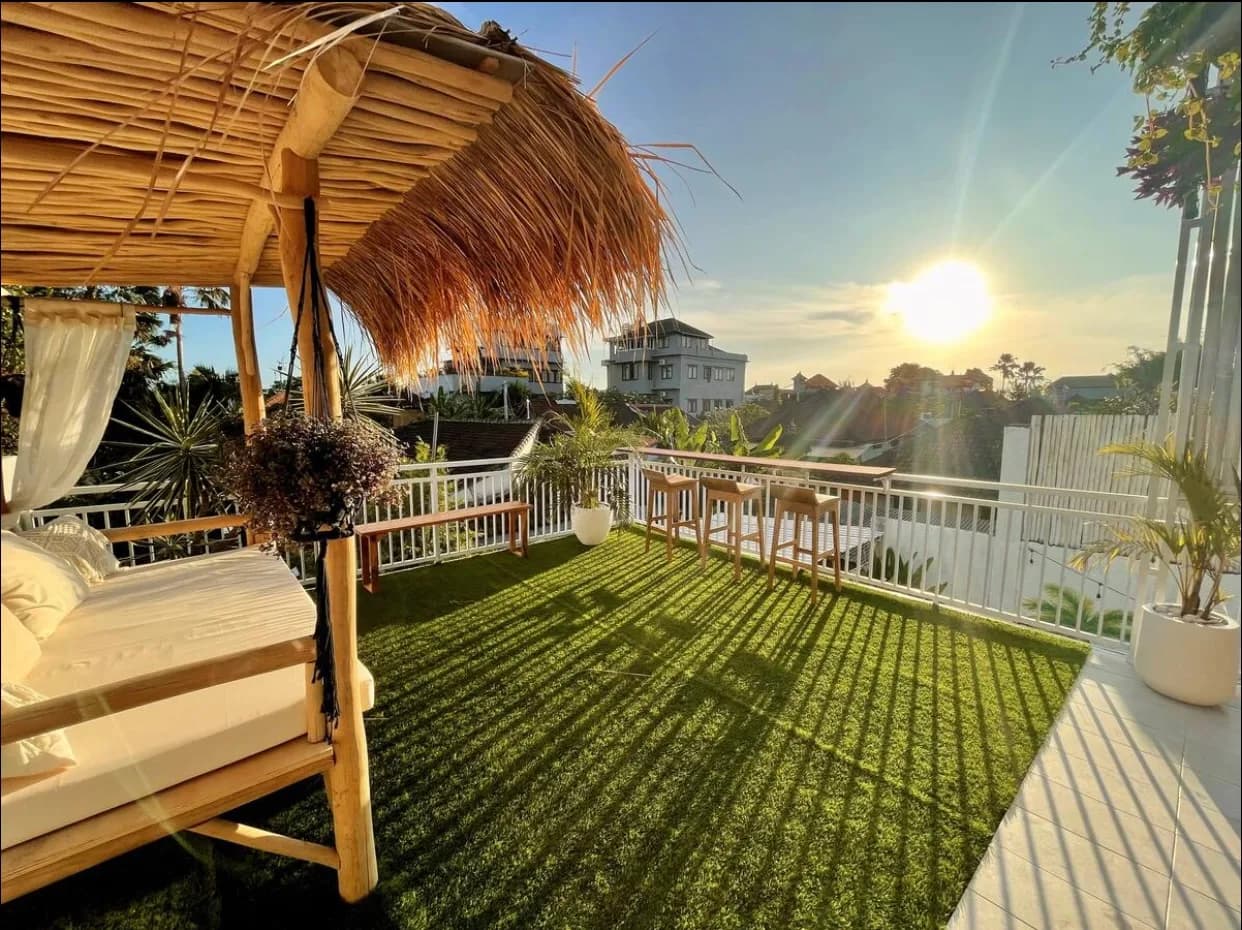 Three-storey white villa exterior with pool at dusk